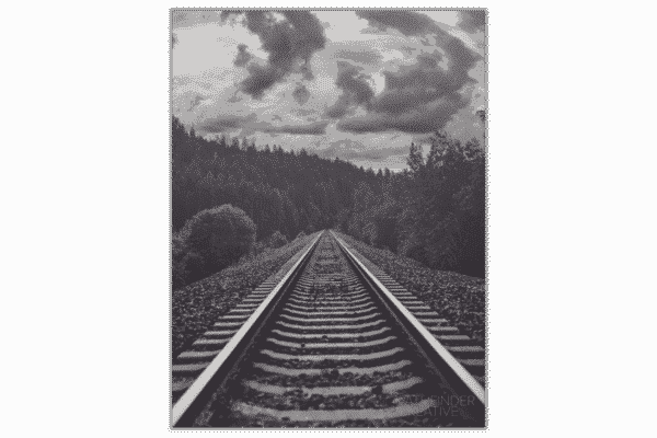 black and white photo of railroad tracks and forest with storm clouds