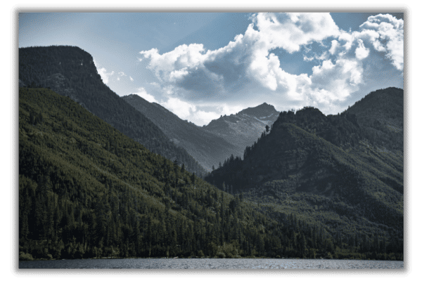 Canvas print of deep green mountains and a lake